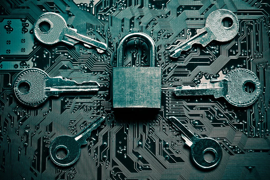 Image of a padlock on a circuit board surrounded by six keys.
