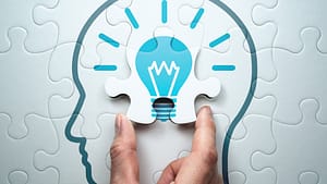 Self Service - IA Solutions Picture of brain with lightbulb symbolizing sef-service help options important to personalizing the customer journey.